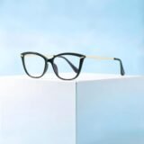 Women's black cat-eye prescription glasses with gold metal temples, lightweight acetate frame for daily fashion wear.
